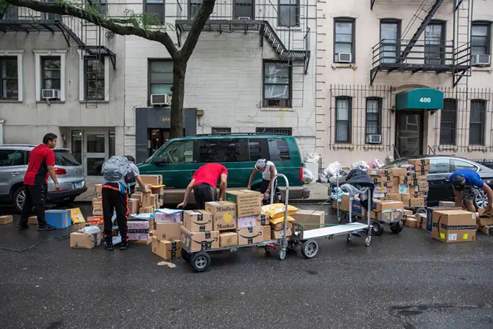 NYC street scene with overflowing packages.